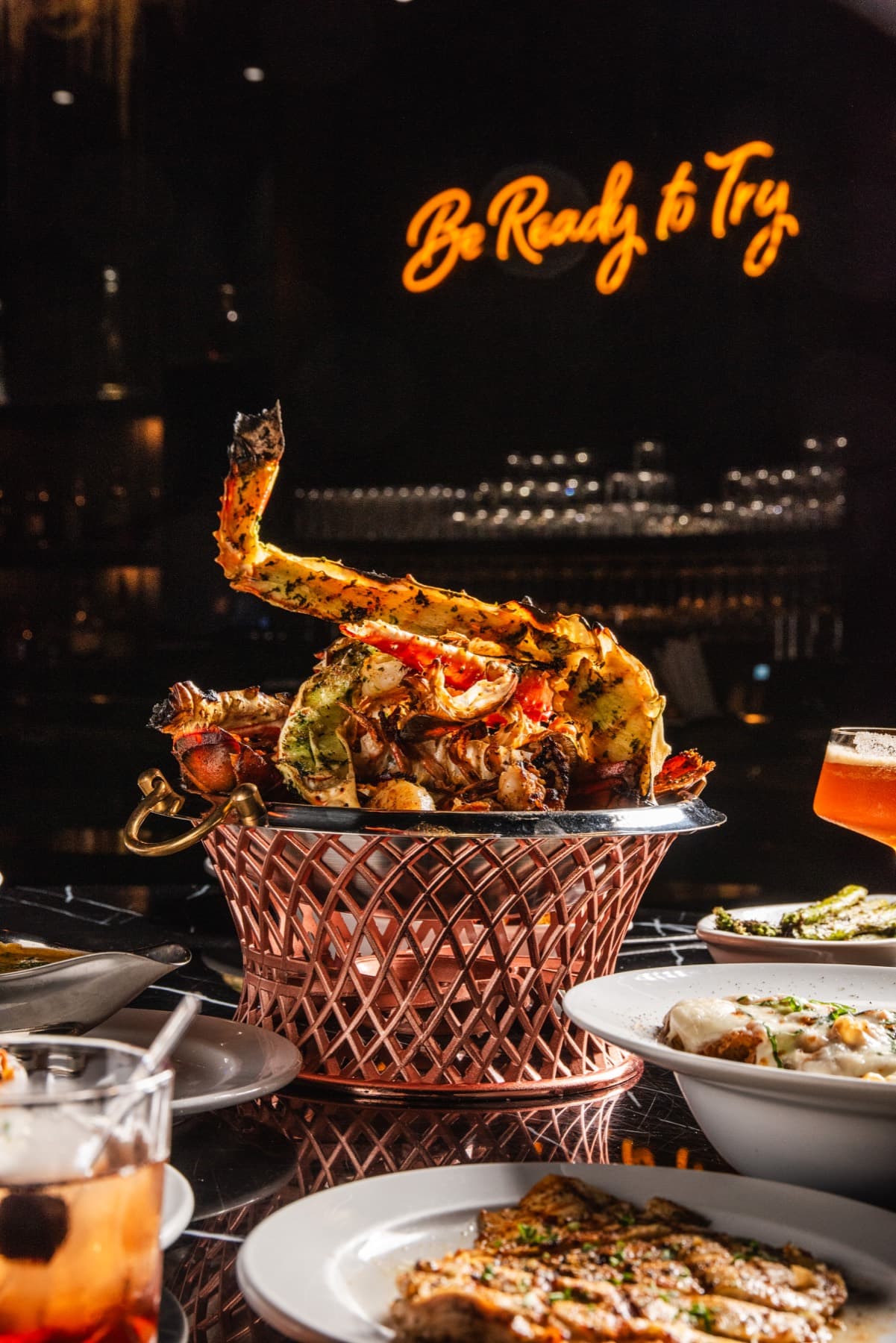 A seafood tower beneath the orange Provaré neon sign