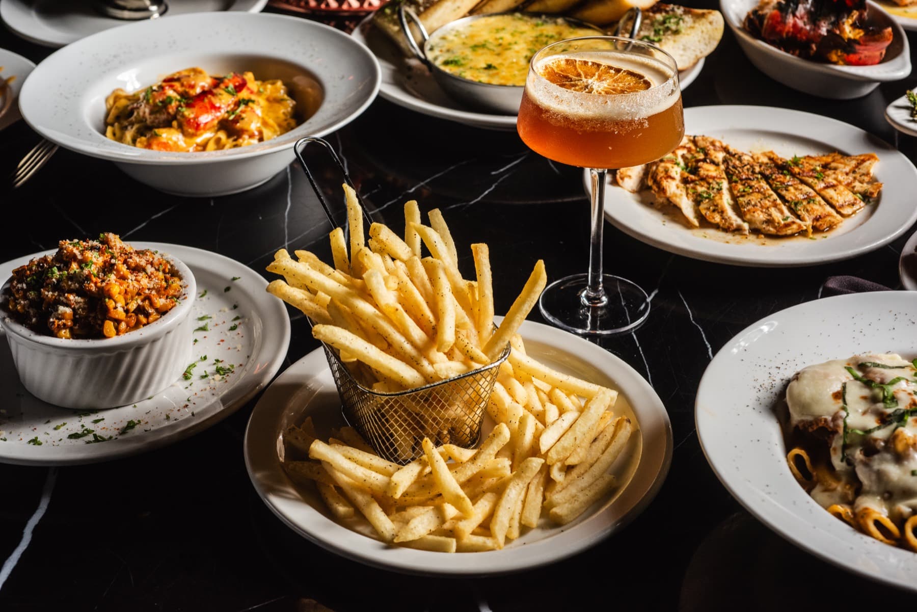 A Provaré dinner spread with fries and cocktails